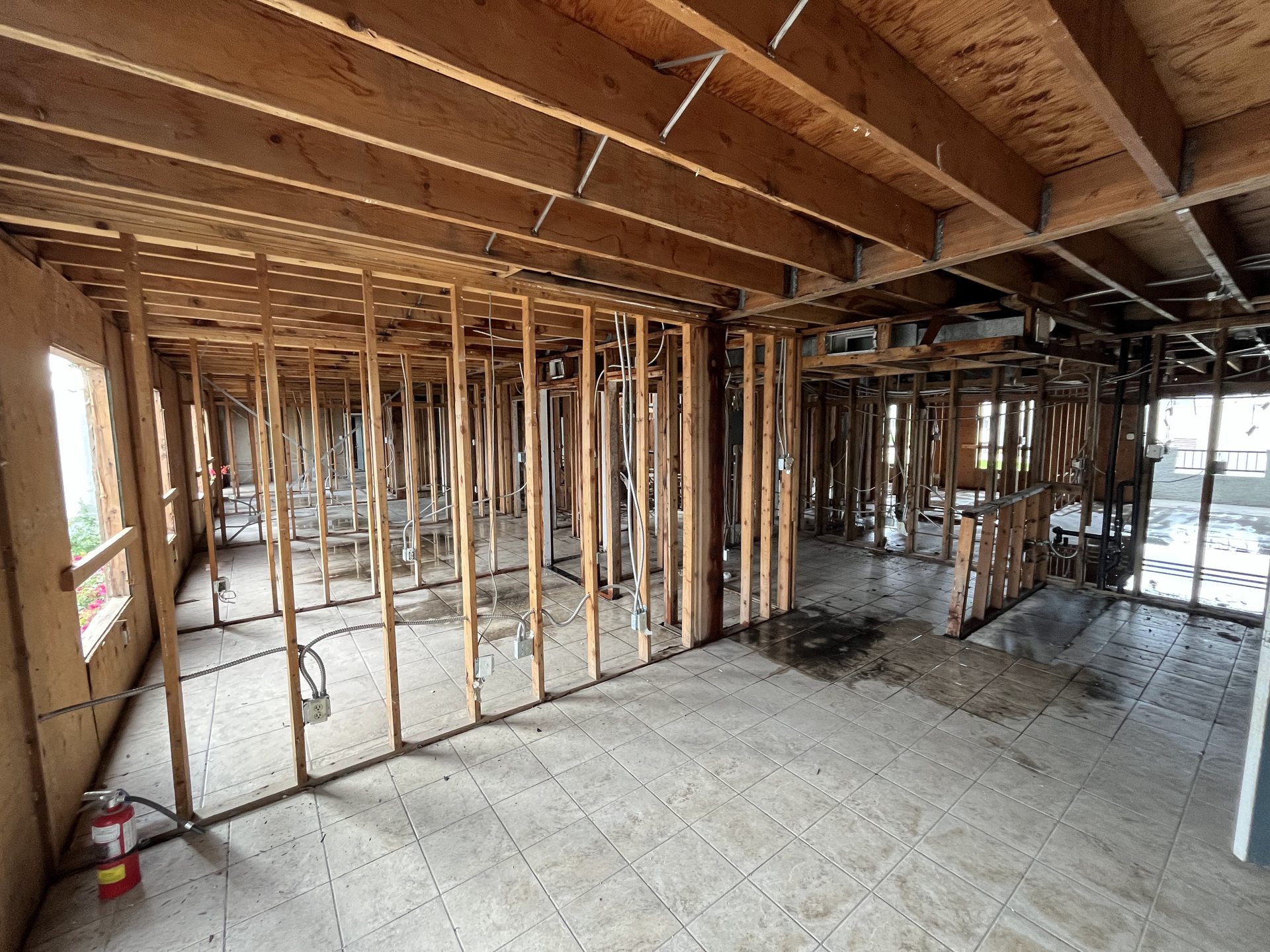 Interior stripped to the studs with new wall framing laying out the re-planned studio and apartment units